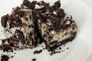A close-up of the No Bake Oreo Cheesecake Bars on a white plate.