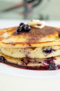 A side view of the Blueberry Buttermilk Pancakes showing how fluffy they are.