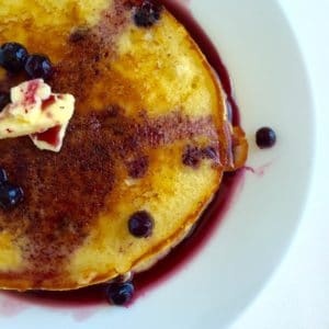 An overhead photo of the buttermilk pancakes with blueberries and butter.