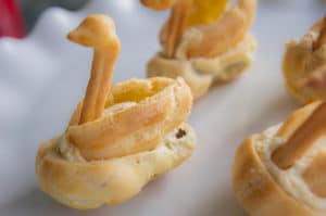 A side-on photo of Cream Puff Swans made from Choux pastry.