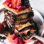 A fork digging into a stack of Nutella & Dark Chocolate Stuffed French Toast.