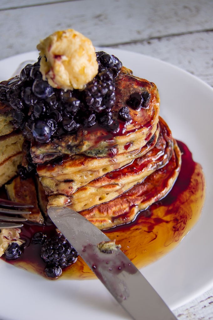 A portrait photo of the pancake stack with brown sugar butter on top.