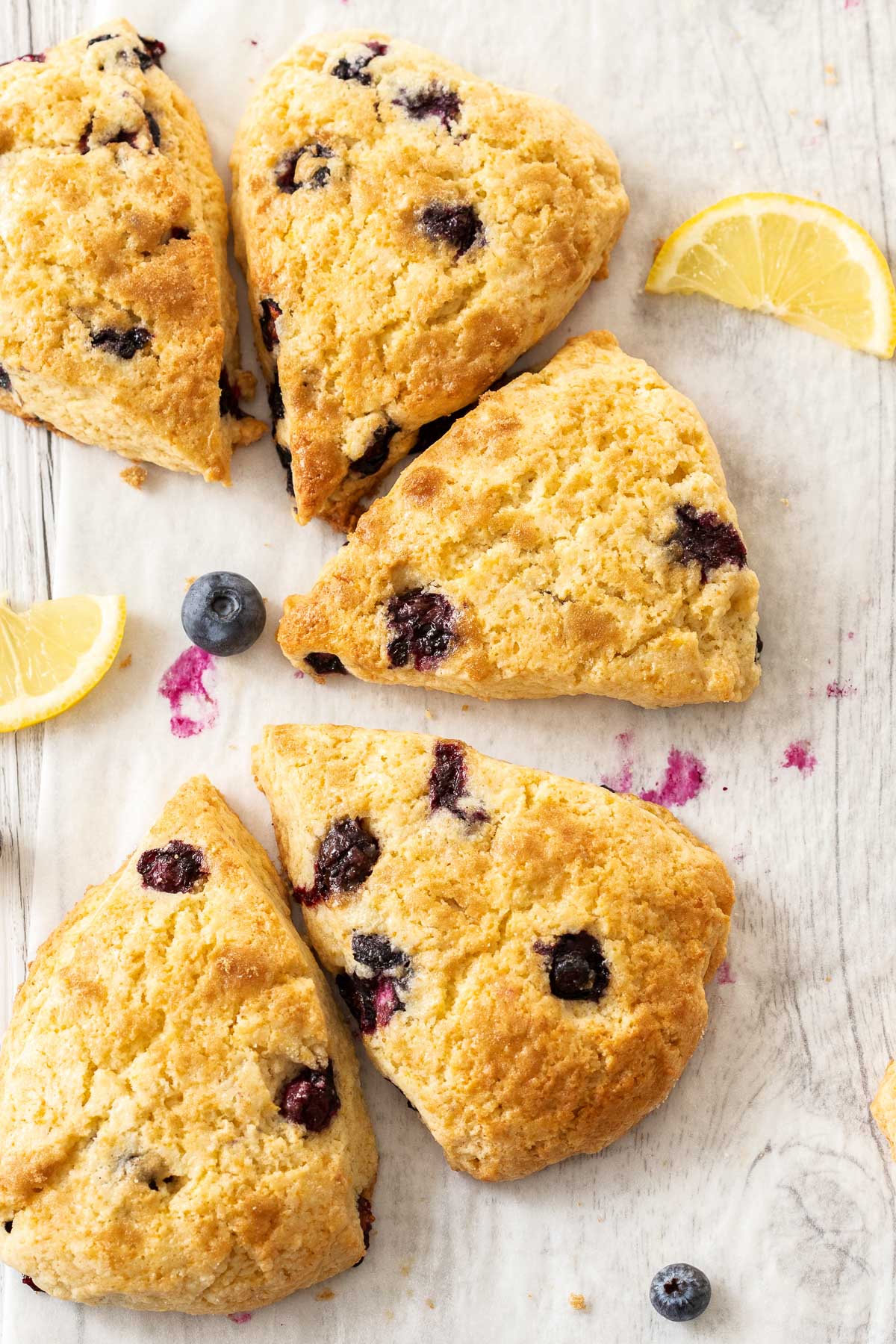 A semi circle made up of several bakery style lemon and blueberry scones.