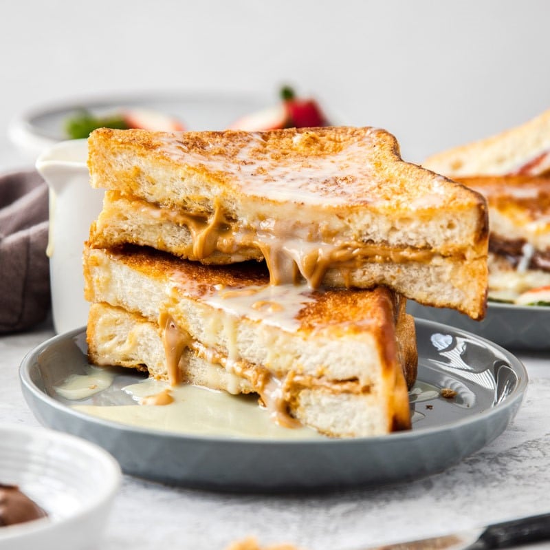 Two Hong Kong French toast sandwiches stacked upon one another. 