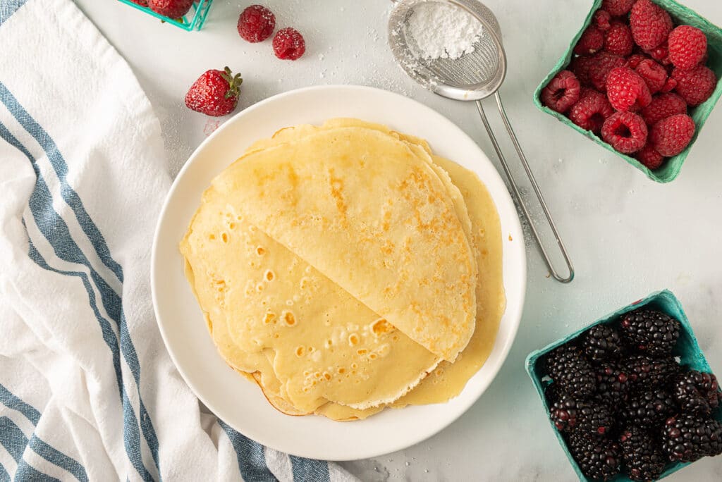 A small stack of traditional french crepes without any toppings or fillings.