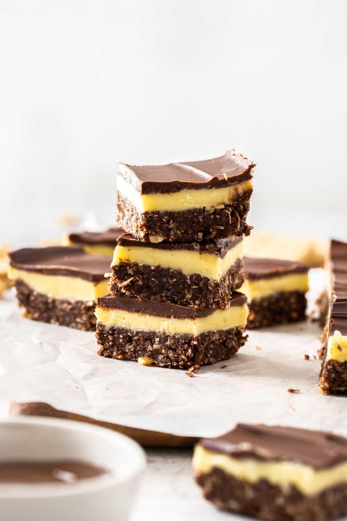 Three Nanaimo Bars stacked atop one another.