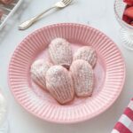 Strawberry madeleines on a pink plate.