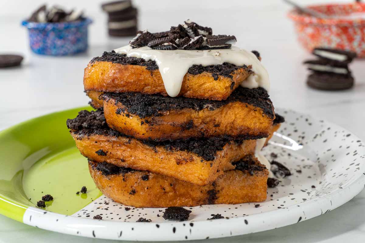 Oreo-stuffed French Toast on a plate. Broken Oreos can be seen in the background.