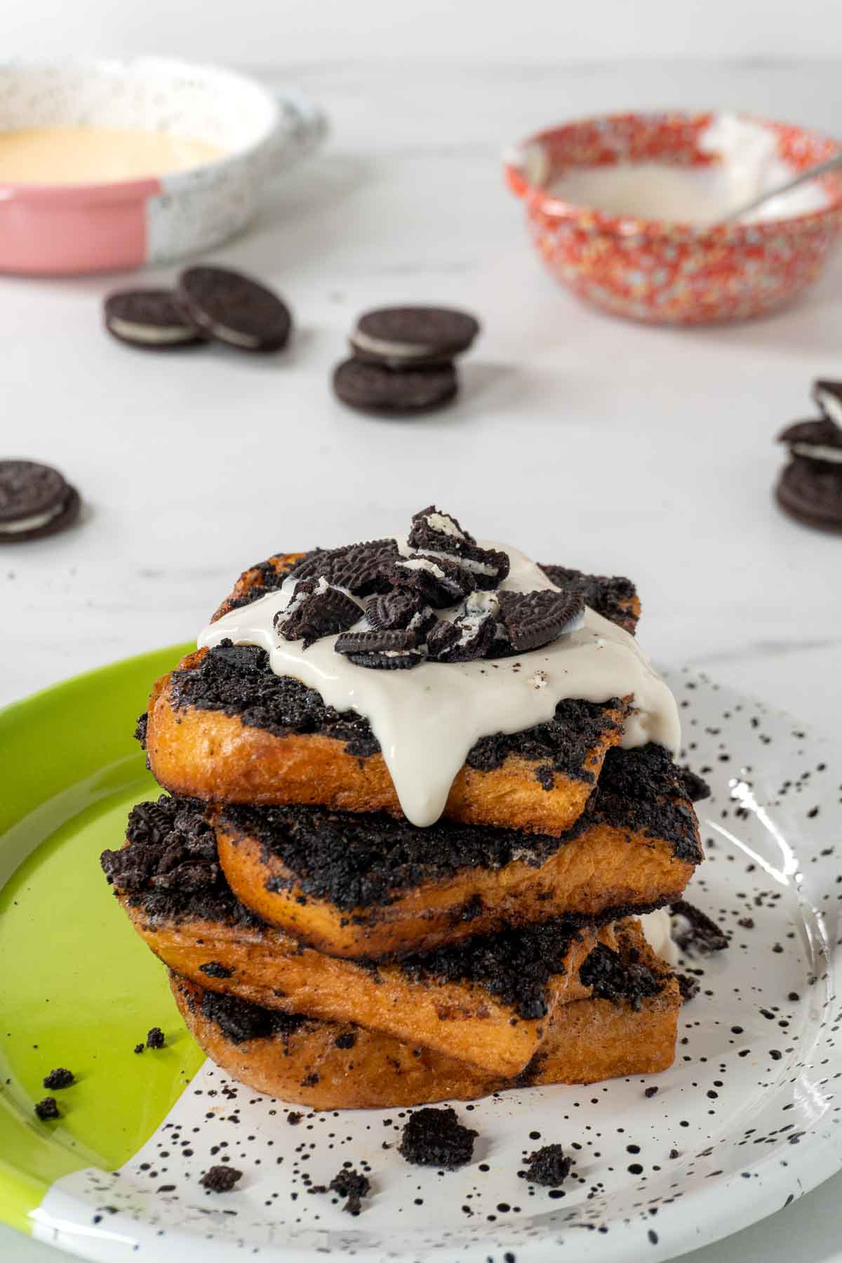 A tall stack of Oreo French toasts on a speckled white and green plate.