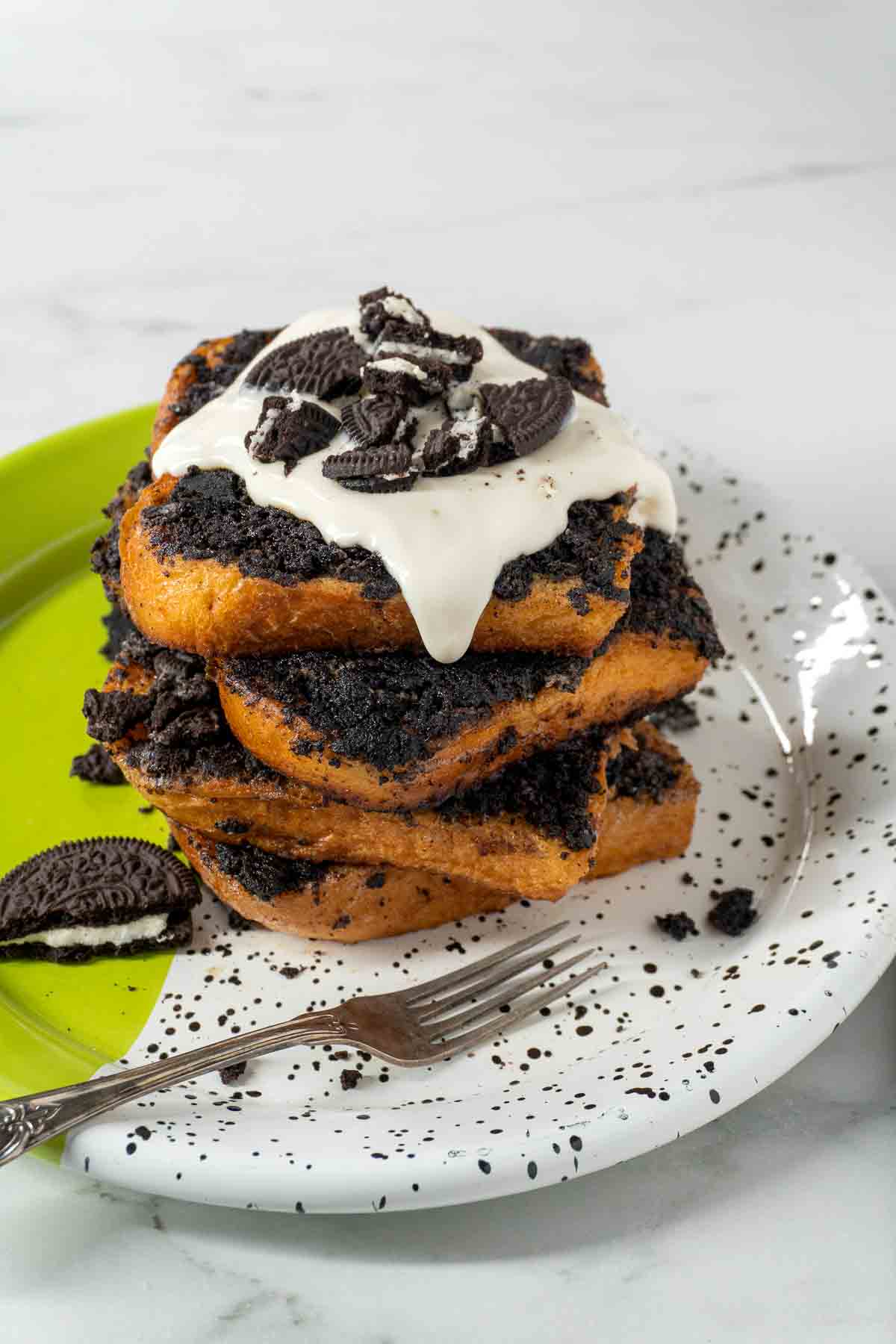 A stack of Oreo French Toast on a plate. A fork is next to the brunch meal, ready to start eating!