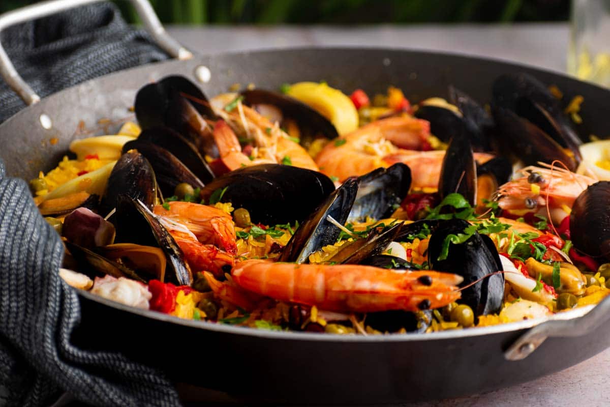 A close-up shot of paella where the seafood is clearly visible.