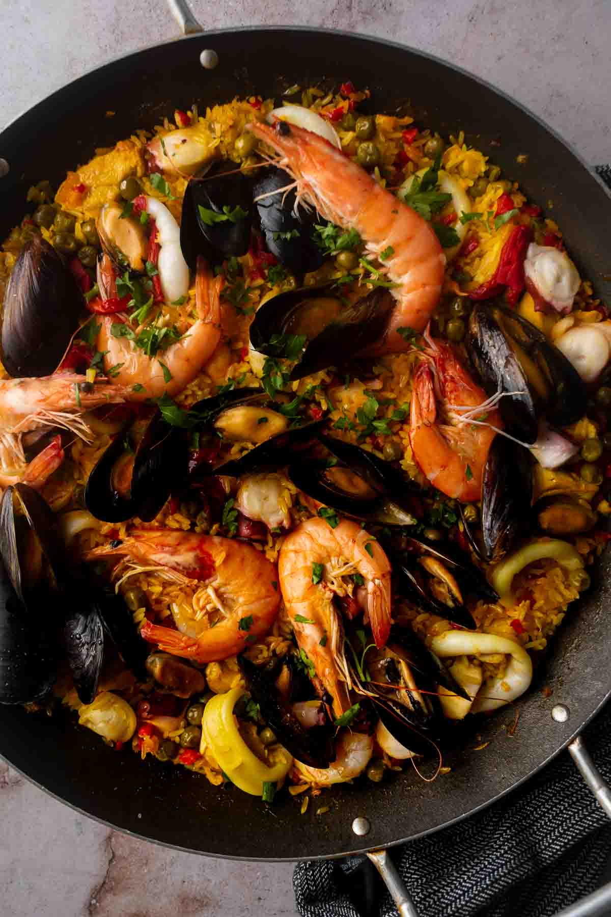 Seafood Paella Valenciana with prawns, chicken, mussels, and calamari.
