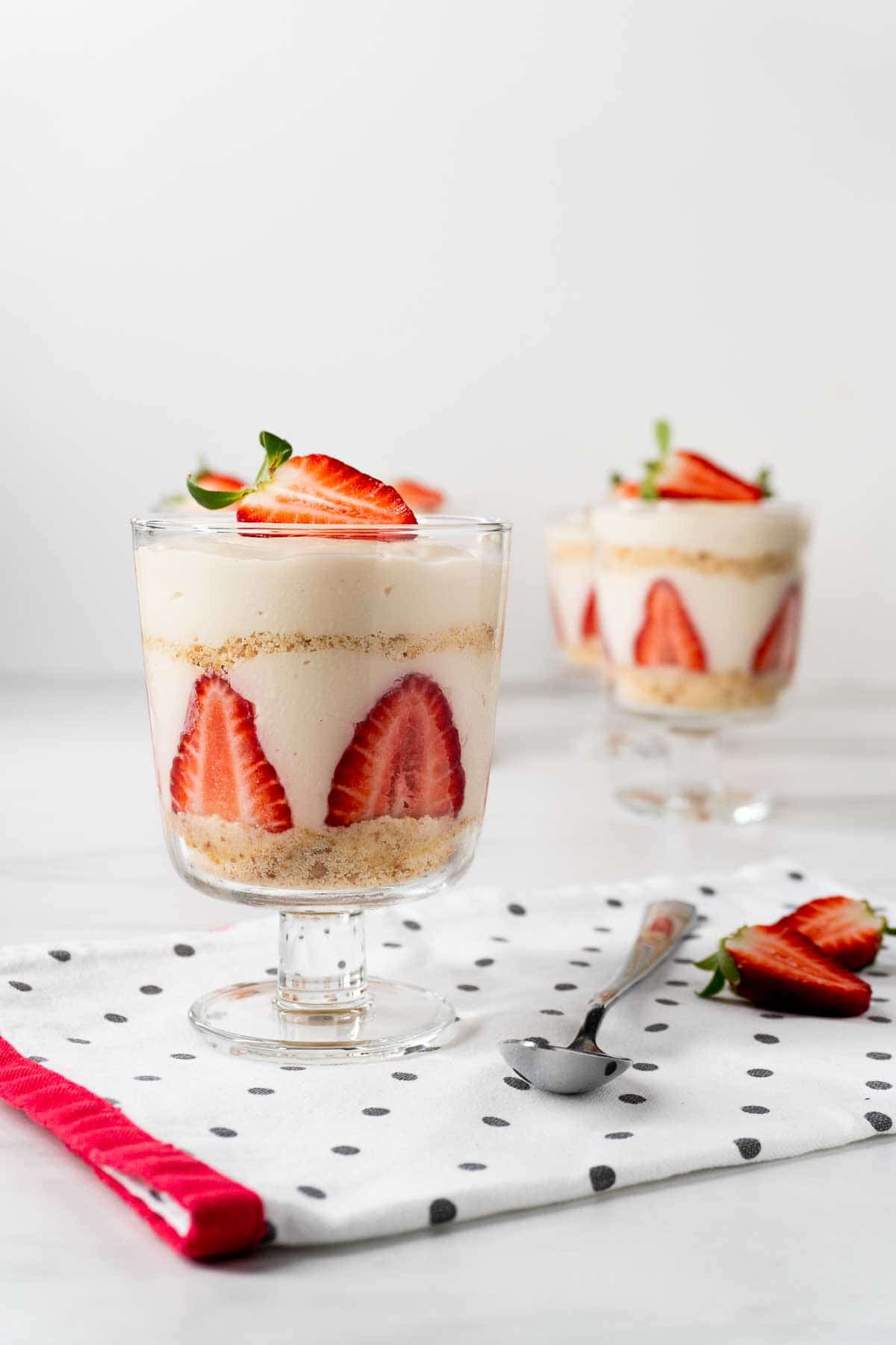 A dessert glass filled with a Turkish strawberry magnolia pudding, made using fresh strawberries.