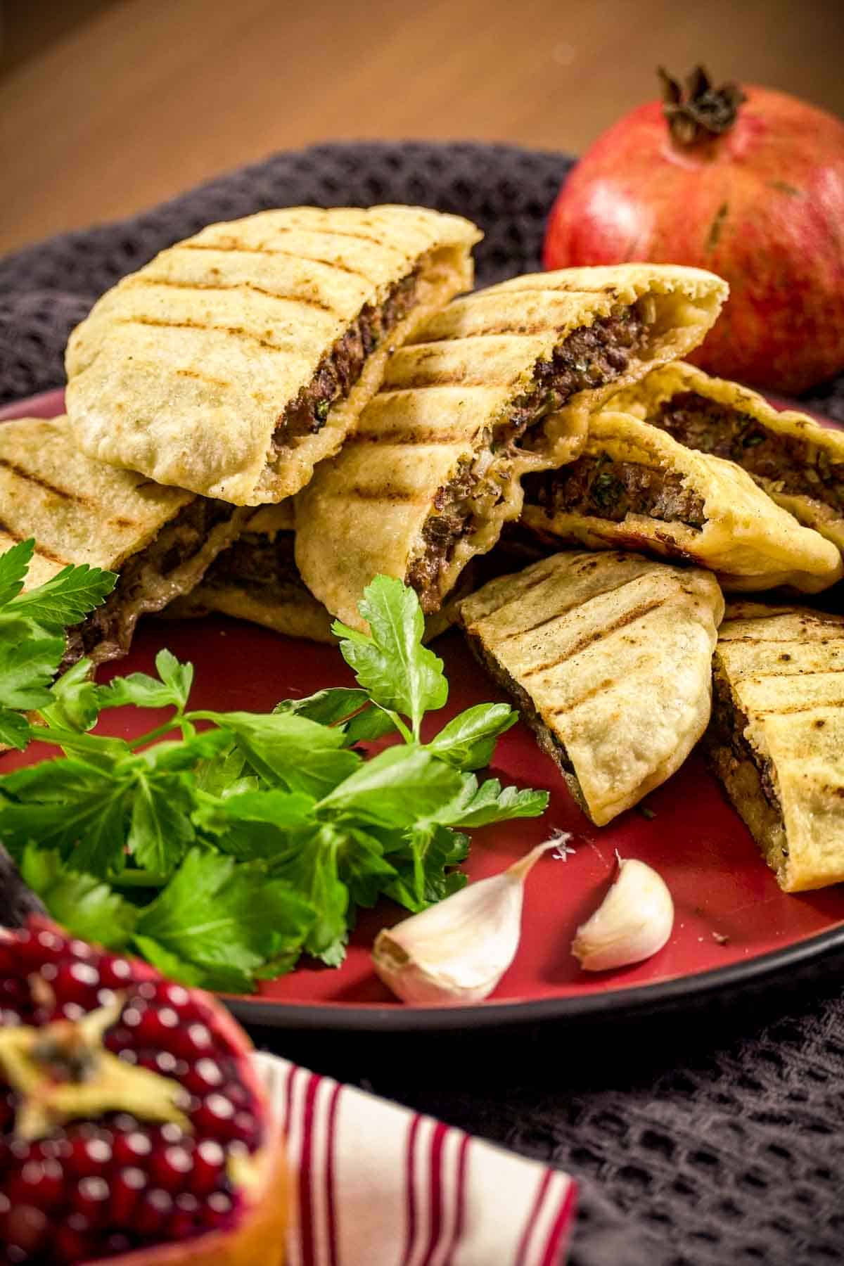 A close up view of arayes pitas, stuffed with beef.