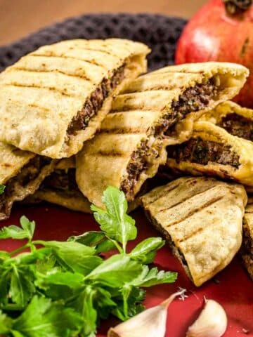 Arayes - Lebanese pitas stuffed with ground beef on a plate.