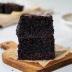 Two rich chocolate-y olive oil brownies stacked in a tower.