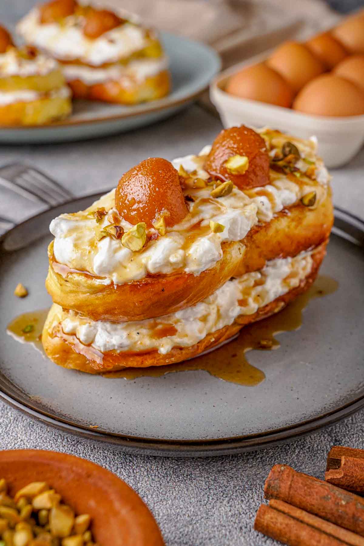 Gulab Jamun French toast, with cream, pistachios, syrup drizzled over.