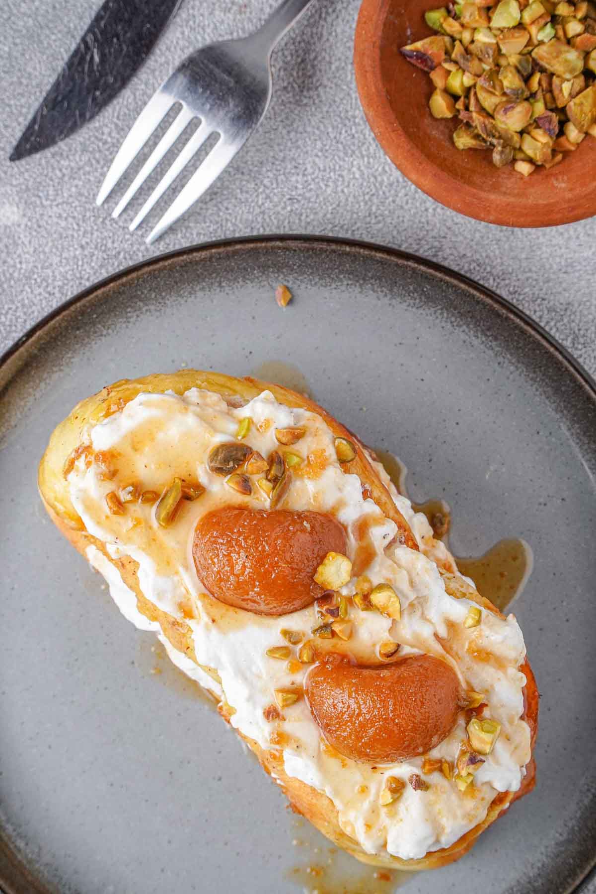 A bird's eye view of the French toast, allowing one to clearly see the gulab jamun pieces resting on the cream layer above the toast.