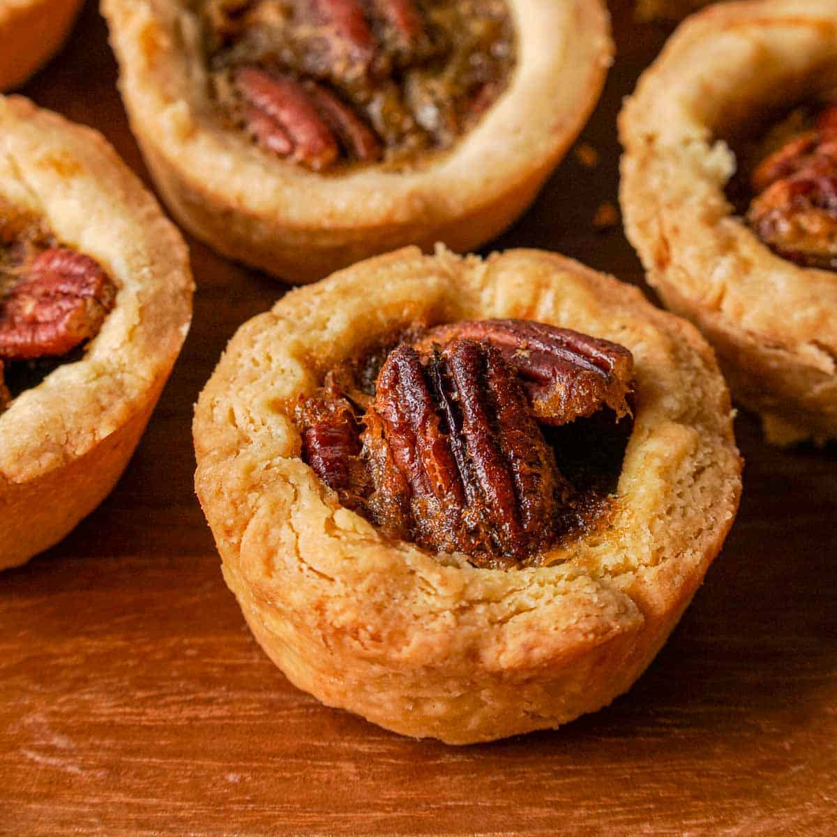 Canadian butter tarts on a wooden background. 