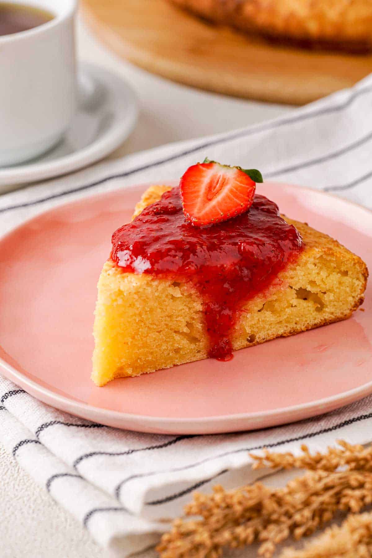 Cottage cheesecake with strawberry sauce and a sliced strawberry topping.