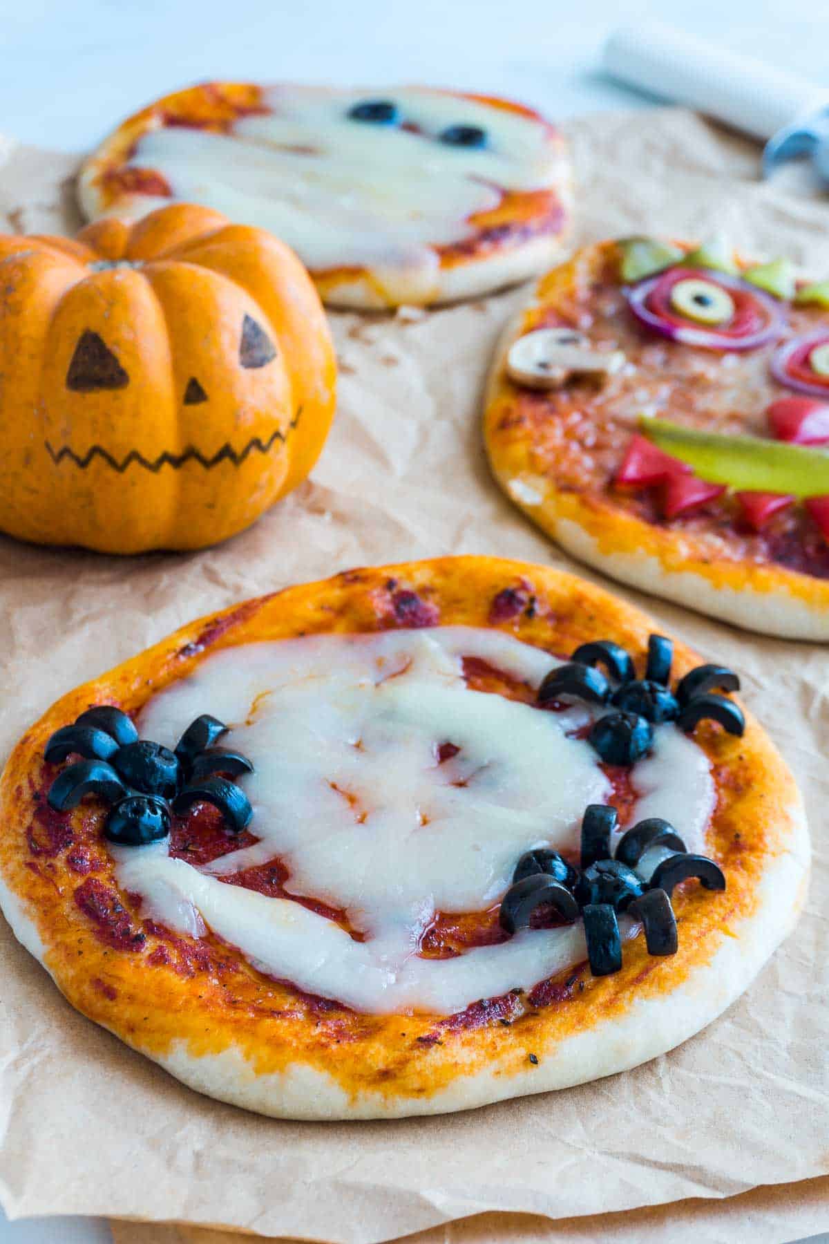 A pizza that uses cheese to create a spider's web, and olives to create spiders.