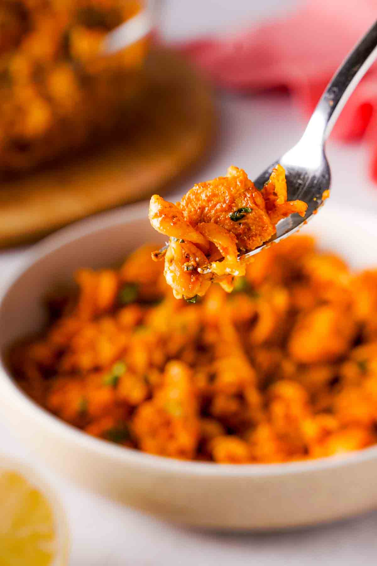A forkful of butter chicken pasta.