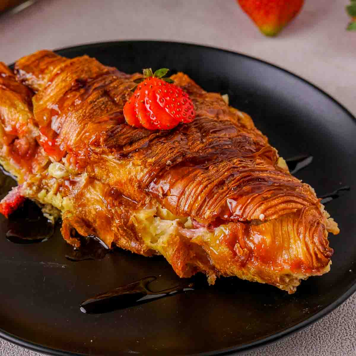 Baked croissant French toast on a plate.