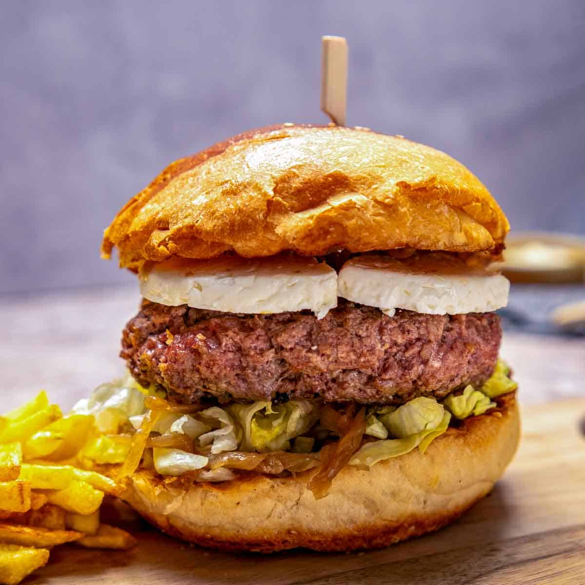 A big burger with goat cheese and caramelized onions