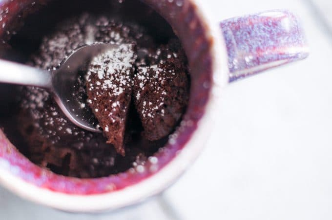 Chocolate mug cake being dug into with a spoon